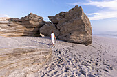 South Africa, Hermanus, Girl (16-17) exploring rock formations on Sopiesklip beach in Walker Bay Nature Reserve