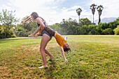 South Africa, Western Cape, Stanford, Girl (16-17) and boy (8-9) playing with water on lawn