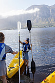 South Africa, Stanford, Boy and teenage girl (10-11, 16-17) preparing for kayaking