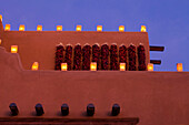 USA, New Mexico, Santa Fe, Traditional farolitos lanterns on adobe building