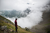 Switzerland, Appenzell, Man hiking in Swiss Alps