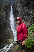 Russia , Karachay-Cherkessia, Arkhyz, Caucasus mountains, Hiker standing near waterfall