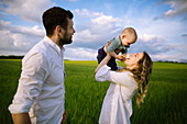 Parents with baby son (12-17 months) in agricultural field
