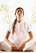 Woman meditating with eyes closed