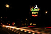 USA, Oregon, Portland. Neon sign in Old Town and traffic blur