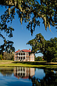 Spanish moss covered tree and the Drayton Hall 18th-century plantation house, Charleston, South Carolina.