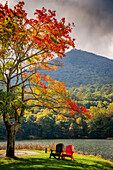 Colorful chairs on the banks of the lake, Peaks Of Otter, Blue Ridge Parkway, Smoky Mountains, USA.