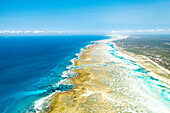 Waves crashing on sandbanks nearby an idyllic blue lagoon, aerial view, Pingwe, Michamvi, Zanzibar, Tanzania, East Africa, Africa