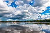 Reflections of clouds in the Casiquiare River in the deep south of Venezuela, South America