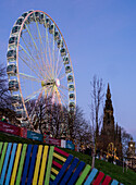 Ferris Wheel with Sir Walter Scott Monument in the background, Christmas time in Edinburgh, Scotland, United Kingdom, Europe