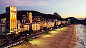 Aerial drone view of Leme Beach in the Copacabana district at sunrise with the iconic Sugarloaf Mountain in the background, UNESCO World Heritage Site, Rio de Janeiro, Brazil, South America