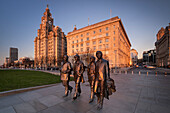 The Beatles Statue and Royal Liver Building at sunset, Pier Head, Liverpool Waterfront, Liverpool, Merseyside, England, United Kingdom, Europe