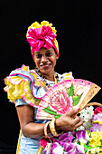 Colourful flower girl with headdress, fan and basket, Havana, Cuba, West Indies, Caribbean, Central America