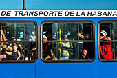 People in packed public bus seen through windows, Havana, Cuba, West Indies, Caribbean, Central America