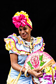 Colourful flower girl with headdress, fan and basket, Havana, Cuba, West Indies, Caribbean, Central America