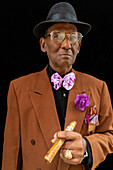 Man standing dressed as 1950s dandy or gangster with fedora hat and big cigar, Havana, Cuba, West Indies, Caribbean, Central America