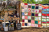 Local quilt blowing in the wind, by coconut shop, Valle de los Ingenios, near Trinidad, Cuba, West Indies, Caribbean, Central America