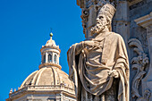 View of statue at the Duomo and Chiesa della Badia di Sant'Agata rotunda from Piazza Duomo, Catania, Sicily, Italy, Mediterranean, Europe