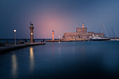 View of Saint Nicholas Fortress, Old Rhodes Town at dusk, UNESCO World Heritage Site, Rhodes, Dodecanese, Greek Islands, Greece, Europe