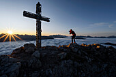 Europe, Italy, Trentino-AltoAdige, Carezza, Dolomites, South Tirol, Bolzano province. Sunrise on the cross of Roda di Vael