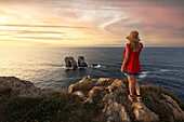 one tourist enjoy the summer sunset near to Manzano rocks, Bajos de Arnia, Cantabria, Spain, Iberian Peninsula, Western Europe