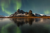 The Northern Lights capture at Eystrahorn mountain, during a cold winter day, Hvalnesviti, Southern Iceland, Europe