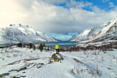 a tourist enjoys the panoramic view of the Ersfdjord, Troms, Norway, Europe