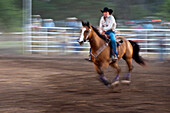 Horse and rider in rodeo barrel racing event.