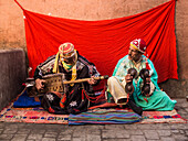 Two gnawa musicians in the narrow streets of the Medina of Marrakesh