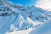 A Mountaineer walking down the Fotsch Valley with Schwarzhorn und Hohe Schöne peaks in the background, Sellrain, Innsbruck Land, Tyrol, Austria, Europe