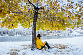 Italy, South Tyrol, Bolzano province, hiker enjoys the peaceful at the Braies lake after snowfall (MR)