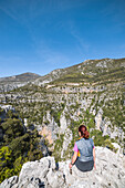 A girl is admiring the Verdon Gorge from the Vidal footpath (Var department, Provence-Alpes-Côte d'Azur, France, Europe) (MR)