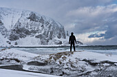 Europe, Norway, Finnmark, Sandfjorden, Hiker on the rocks
