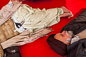 Pilgrims (Couple) sleeping, after a hard trip, inside of Golden temple, Amritsar, Punjab, India