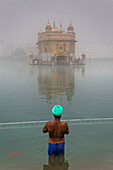 pilgrim bathing in the sacred pool Amrit Sarovar, Golden temple, Amritsar, Punjab, India