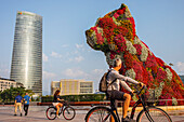 Iberdrola tower and Puppy by Jeff Koons, in front of the Guggenheim Museum, Bilbao, Spain