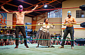 Lucha Libre.Two spontaneous up to the ring to help the cholita Angela la Folclorista during the combat again the wrestler called El Prisionero, Sports center La Ceja, El Alto, La Paz, Bolivia