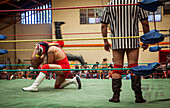 Lucha Libre. Wrestlers in combat, and referee, Sports center La Ceja, El Alto, La Paz, Bolivia