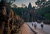Woman, women, biking, Bridge and South Gate of Angkor Thom, Angkor, Siem Reap, Cambodia