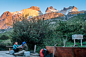 Hikers resting in Cuernos refuge, You can see the amazing Cuernos Del Paine, Torres del Paine national park, Patagonia, Chile