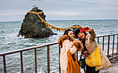 Tourists,Meoto-Iwa, Wedded Rocks off the coast of Futamigaura Beach, Futami Town on the in Mie Prefecture, Japan.
