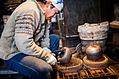 Takahiro Koizumi is putting the finishing touches at iron teapots or tetsubin, nanbu tekki,Workshop of Koizumi family,craftsmen since 1659, Morioka, Iwate Prefecture, Japan