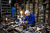 craftsman is putting the finishing touches at iron teapot or tetsubin, nanbu tekki, in Workshop of Morihisha Suzuki,craftsmen since 1625, Morioka, Iwate Prefecture, Japan