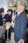 Friends saying goodbye, at Shinjuku Railway station, Tokyo, Japan.