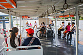 Passengers on express ferry boat, Chao phraya river, Bangkok, Thailand
