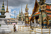 Demon Guardians statues and tourist, Emerald Buddha Wat Phra Kaeo temple, Grand Palace, Bangkok, Thailand