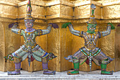 Statues of demons on a Golden Chedi, at the temple of the Emerald Buddha Wat Phra Kaeo, Grand Palace, Bangkok, Thailand