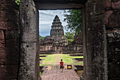 Tourist, Passage way and central sanctuary from Outer Southern Gopura, in Prasat Hin Phimai (Phimai Historical Park), Phimai, Nakhon Ratchasima province, Thailand