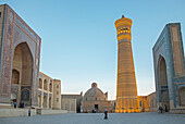 At right Kalon minaret and mosque. At left Mir-i-Arab medressa , Bukhara, Uzbekistan