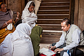 Dr.Ghopal; Doctor of NGO SOS Woman examining widows, Vrindavan, Mathura district, India